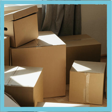 A stack of cardboard moving boxes in an empty room
